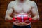 Christmas. Muscular Fighter kickbox boxing Santa Claus With Red Bandages the background of a brick wall. Holds a red