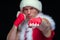 Christmas. Muscular Fighter kickbox boxing Santa Claus With Red Bandages isolated on black background.