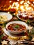 Christmas mushroom soup, a traditional vegetarian  mushroom soup made with dried forest mushrooms in a ceramik plate on a festive