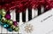 Christmas music concept. Printed music on the piano with jingle bells, snowflake and spangle