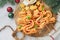 Christmas or New Year appetizer. Christmas tree shape puff pastry buns with cheese and ham. Group of Christmas tree shapes on wood