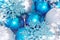 Christmas and New Year background. blue and silver sparkling balls, snowflake ornaments