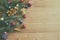 Christmas or new year background with fir tree branches and variety multicolored decorations on wooden table