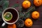 Christmas new year background with tangerines, tea with lemon. winter still. selective focus