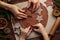 Christmas and New Year bakery. Close up of kids and female hands  cooking traditional gingerbread cookies.  Wooden kitchen table