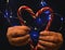 Christmas and New year candy red heart in female hands and lights beautiful holiday blue background