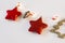 Christmas or new year card with bright red Christmas stars, Christmas tree toys, garland with lights on a white background