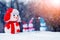 Christmas and New Year card with snowmen in the winter forest during a blizzard in the light of the evening sun