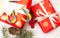 Christmas and New Year composition. Christmas gift, pine cones, fir branches, lollipops, red berry on wooden white background