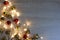 Christmas and New Year composition from red and golden shiny and matte balls and christmas lights on light wood background