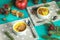 Christmas and New Year composition with sweet delicious apples dessert, spruce branches, cutlery on blue turquoise wooden table