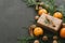 Christmas New Year Composition with Tangerines Boxes Pine cones Greens in Black Background Holiday Decoration Toned