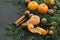 Christmas New Year Composition with Tangerines Pine cones Greens nuts cinnamon on Black Background Holiday Decoration Toned