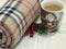 Christmas and New Year composition. Warm woolen winter blanket and Santa Claus cup of hot chocolate / cocoa.