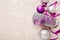 Christmas or New Year composition. Xmas purple and silver decorations: ribbons and balls on pink pastel background. Flat lay, top