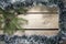 Christmas and New Year Concept. Fir tree branch with cones in a frame tinsel, garland on wooden board, Top view, flat lay