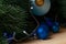 Christmas or New Year decoration background: fur-tree branches, colorful glass balls on wooden background.