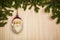 Christmas or New Year decoration background with hanging Santa Claus in pine branches on a wooden table with copy space