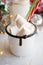 Christmas New Year drink, white mug with marshmallows and Candy Cane straw on hygge cozy interior background.