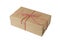 Christmas and New Year gift box wrapped in brown craft kraft paper with red and white baker's twine