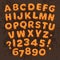 Christmas, New Year gingerbread cookies alphabet isolated on dark chocolate background. Cartoon letters and numbers