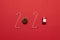 Christmas and New Year holiday 2020 inscription from various decorated objects classic red glass baubles ball, toy car on a red