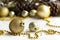 Christmas and New Year holiday background with decorations and beads. Gold shining balls, fir cones, jingle bells and star