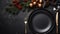 Christmas and New Year luxury table setting for dinner on dark background top view