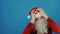 Christmas and New year, man like a Santa disappointed and shakes his head, on blue background