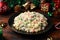 Christmas and New year Olivier salad, traditional Russian food with decoration, gifts, green tree branch on wooden