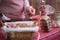 Christmas, New Year pastry shop. Woman waitress entering data of credit card using tablet for selling gingerbread cookies, sweets