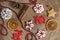 Christmas and New Year pattern from ginger cookies, slices of orange, cinnamon, pine cones, red beads and deers on a wooden