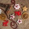 Christmas and New Year pattern from ginger cookies, slices of orange, cinnamon, pine cones, red beads and deers on a wooden