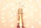 Christmas or New Year pink background with  bottle of sparkling wine, rose champagne and gold decor, top view