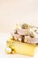 Christmas or New year round kraft gift boxes, gold holiday balls on a bokeh background of twinkling party lights of garland