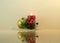 Christmas New Year`s composition of a Christmas ball, a burning candle, a fir-tree branch with berries and glittering beads on t