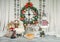 Christmas and New Year\\\'s interior with a large wall clock, decorated with toys, fir branches and garlands.