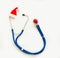 Christmas, New Year`s medical flatlay. Stethoscope, gift, Christmas decorations on a white background. Copy space