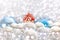 Christmas and New Year`s toy fairy tale red house in snowdrifts and snow of Christmas balls and tinsel in blue and white colors