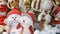 Christmas and New Year`s toy statues in the form of angels, deer, snowmen in Santa Claus hats that are spinning on