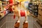 Christmas, New Year sale, shopping. Funny Christmas deer on supermarket trolley. Basket in wholesale store, blurred groceries and