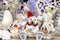 Christmas and New Year toys and decorations near Christmas tree. Funny beautiful polar bear, penguin, Santa Claus, dolls in