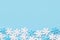 Christmas New Years background white blue snow flakes on cyan backdrop. Minimalist elegant style for holiday poster banner