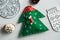 Christmas, new years decor on a wooden white background. Tree, a mitten, a ball, lump, nut.