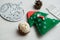 Christmas, new years decor on a wooden white background. Tree, a mitten, a ball, lump, nut.