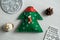Christmas, new years decor on a wooden white background. Tree, a mitten, a ball, lump, nut