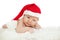 Christmas newborn baby in santa hat. Winter child on winter whit