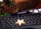 Christmas at the office. A handmade star on the keyboard. Close-up. Gifts.