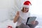 Christmas online congratulations. Joyful girl in santa hat