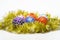 Christmas ornaments balls lay on golden tinsel as eggs in nest. Balls for decoration on shimmering tinsel, white